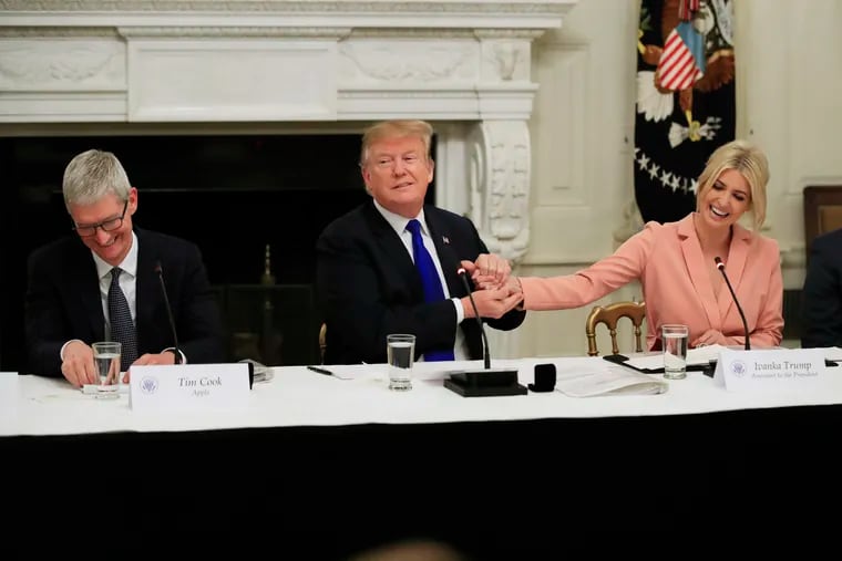American Workforce Policy Advisory Board co-chair Ivanka Trump, right, and Apple Inc. CEO Tim Cook, left, react as President Donald Trump thank his daughter during the advisory board's first meeting in the State Dining Room of the White House in Washington, Wednesday, March 6, 2019. Ivanka Trump has proposed expanding affordable child care and parental leave nationwide.