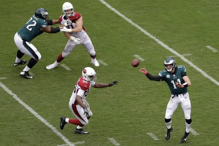 Eagles quarterback Carson Wentz (right) passes during the second half of the Eagles win over the Cardinals.