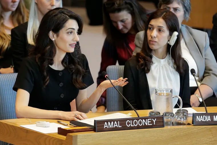 While Nadia Murad Basee Taha, right, listens, Amal Clooney speaks during a Security Council meeting on sexual violence at United Nations headquarters, Tuesday, April 23, 2019. (AP Photo/Seth Wenig)