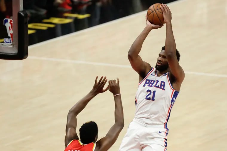 Sixers center Joel Embiid shoots over Atlanta Hawks center Clint Capela in Game 3 of the NBA Eastern Conference playoff semifinals on Friday, June 11, 2021 in Atlanta.