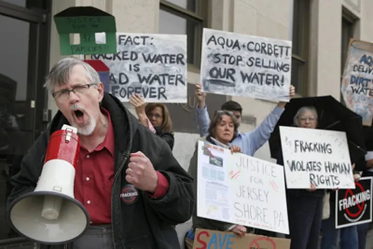 Nathan Sooy, Pa. coordinator for Clean Water Action, speaks at a protest in front of Aqua America headquarters in Bryn Mawr. (Michael S. Wirtz / Staff Photographer)