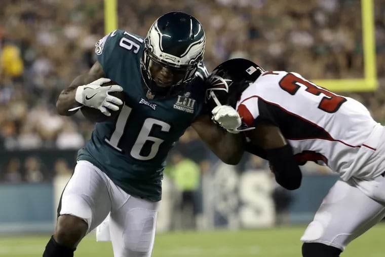 Eagles receiver DeAndre Carter is tackled by Atlanta's Brian Poole on Thursday.