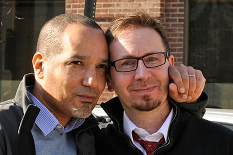 Mark Himes (left) and Frederic Deloizy after meeting with an immigration officer in Philadelphia for a green card. (TOM GRALISH / Staff Photographer)