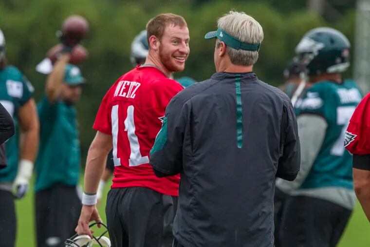 Eagles coach Doug Pederson re-emphasized that Carson Wentz will still be the team's starting quarterback when he is healthy again. "He's our guy," Pederson said.

Eagle quarterback Carson Wentz, #11, turns to smile back at head coach Doug Pederson during Tuesday’s practice.    08/15/2017  MICHAEL BRYANT / Staff Photographer