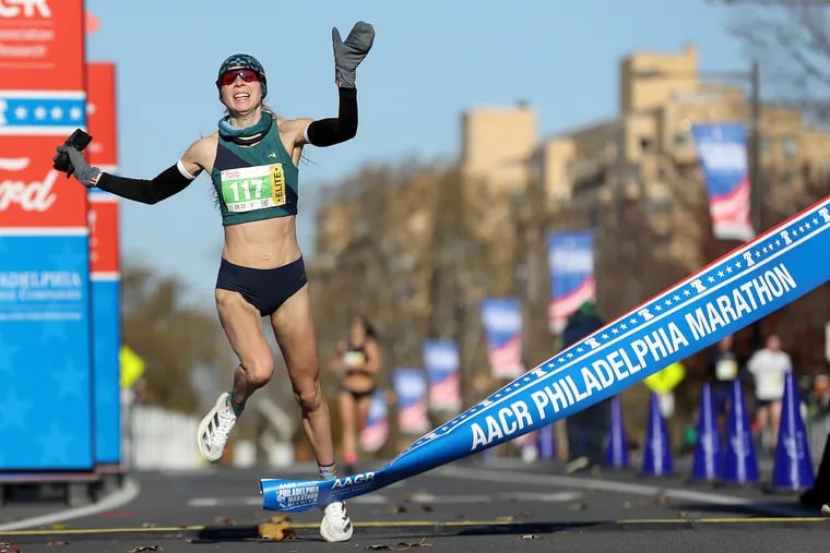 Amber Zimmerman  of Philadelphia crosses the finish line as the first female runner in the Philadelphia Marathon on Sunday.