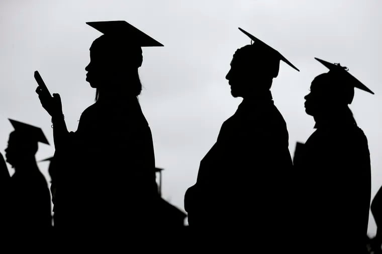 In this May 17, 2018, file photo, new graduates line up before the start of the Bergen Community College commencement at MetLife Stadium in East Rutherford, N.J. Many new college graduates are struggling to find work as their first student loan payments loom on the horizon. Fewer entry-level jobs are available during the pandemic, and unemployment benefits typically aren’t accessible.