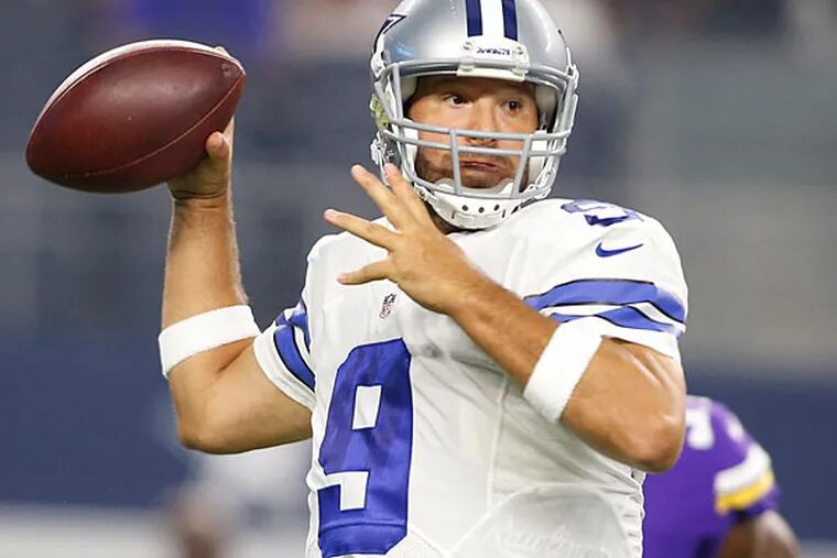 Dallas Cowboys quarterback Tony Romo (9) throws a pass in the first quarter against the Minnesota Vikings at AT&T Stadium.