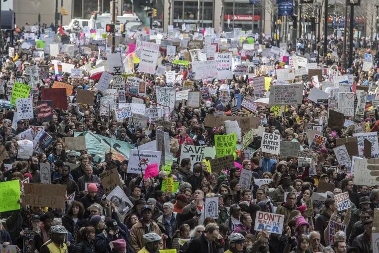 A sea of demonstrators march around the south side of Philadelphia City Hall towards the Loew’s Hotel where President Trump is addressing the GOP congressional delegation retreat January 26, 2017. CLEM MURRAY / Staff Photographer YEAREND2017-be