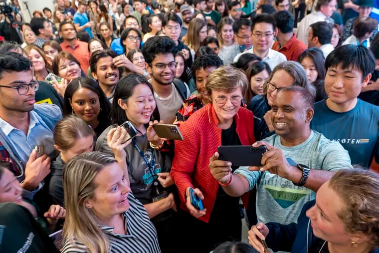 Katalin Karikó (red jacket) is swarmed by selfie-seeking “flash mob” at the University of Pennsylvania Monday when she and colleague Drew Weissman won the Nobel Prize in medicine.