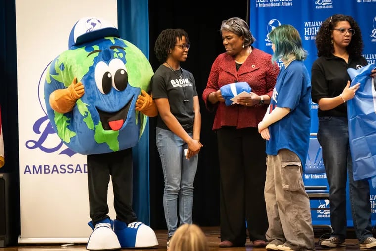 United Nations Ambassador Linda Thomas-Greenfield, center, receives a gift from student Jada Davis, second from left, on stage at the Bodine High School for International Affairs during Thomas-Greenfield’s visit on Tuesday.