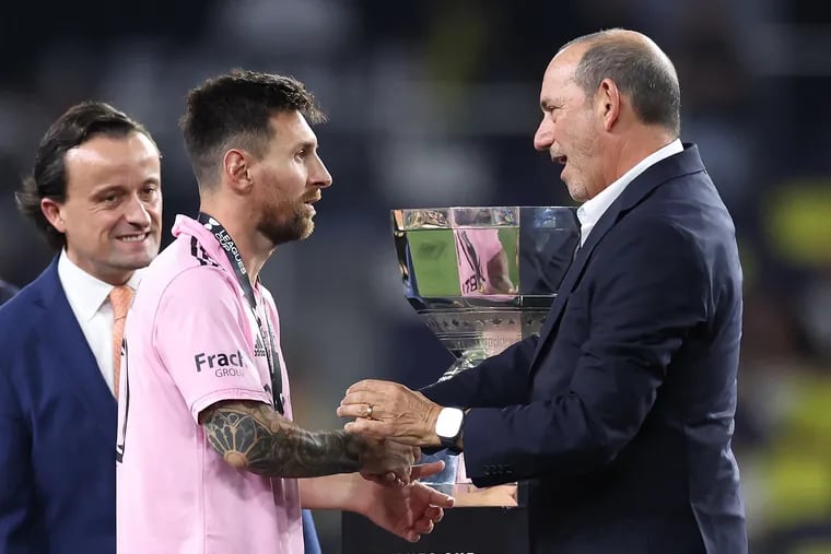 MLS commissioner Don Garber (right) shakes hands with Lionel Messi (center) after Messi helped Inter Miami win last year's Leagues Cup.