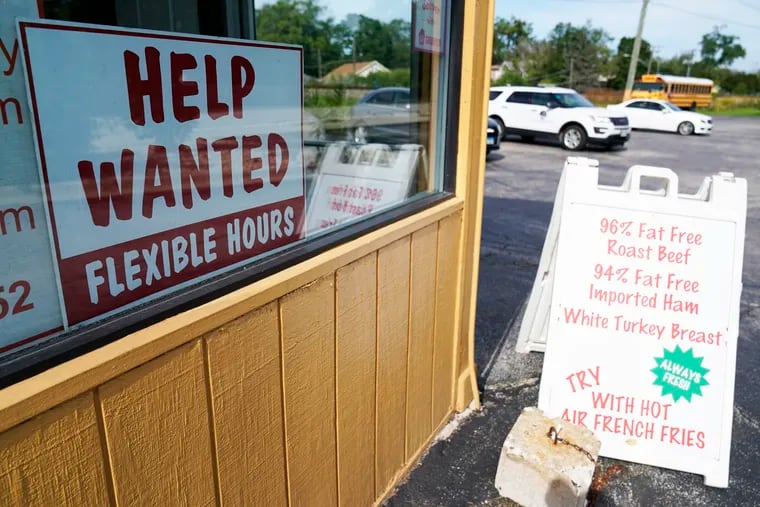 A help wanted sign is displayed in Deerfield, Ill., Wednesday, Sept. 21, 2022. The U.S. government will issue the October jobs report on Friday morning.
