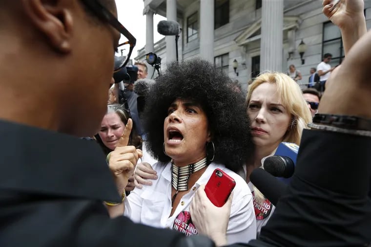Lili Bernard, center, who is among the women to accuse Bill Cosby of sexual assault, confronts a Cosby supporter outside the Montgomery County Courthouse on Thursday.