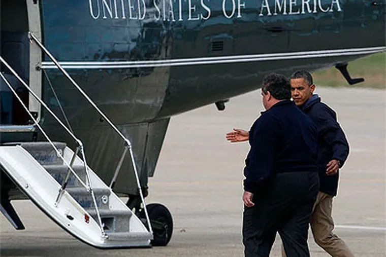 President Obama escorts N.J. Gov. Christie to the helicopter Marine One, at Atlantic City International Airport, before the two toured storm-damaged towns. (David Maialetti / Staff Photographer)
