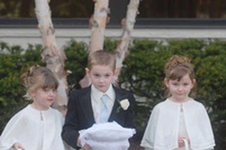 Nieces and a nephew of the bride - Kelly Bubser (left), Jake Rattigan, and his sister Mackenzie - handled flower-girl and ring-bearer duties.