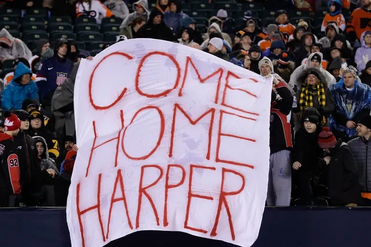 Fans hold a sign asking for Bryce Harper to join the Phillies before the Flyers and Pittsburgh Penguins played their Stadium Series game at Lincoln Financial Field on Saturday, Feb. 23, 2019.