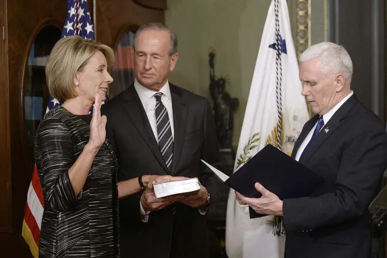 Vice President Pence swears in Betsy DeVos as the education secretary last week in the White House.