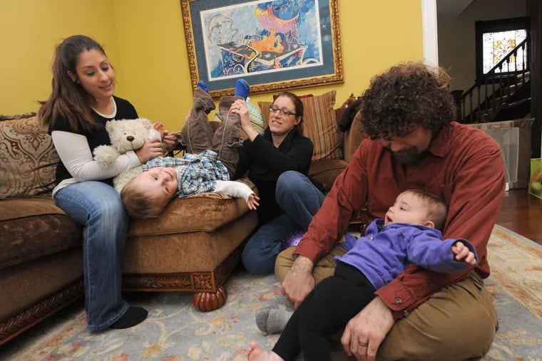 Parents Brendan Krivda and Lindsey Rosenberg (center) and babysitter Cara Morganstein play with Cole, 2, and Amelia, 10 months.