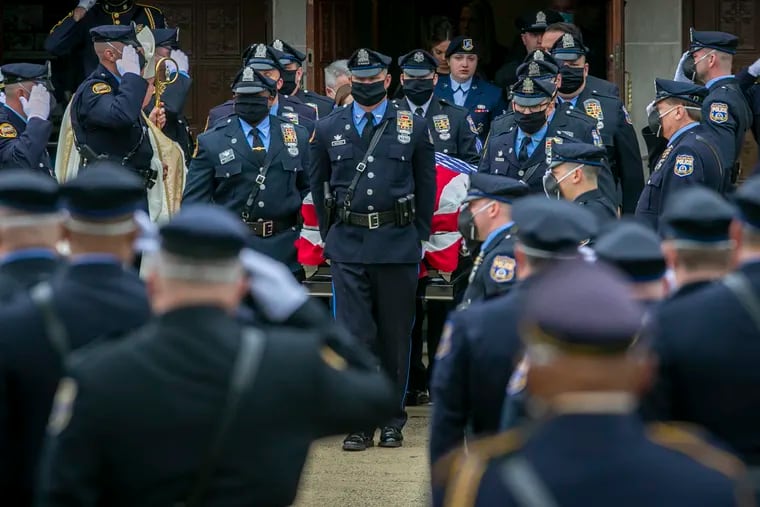 The body of slain Philly Police Cpl. James O'Connor IV leaves the Our Lady of Calvary Church in Northeast Philadelphia on Friday, May 8, 2020. O'Connor was shot and killed during a SWAT raid in Frankford in March; his funeral was delayed due to the coronavirus pandemic.