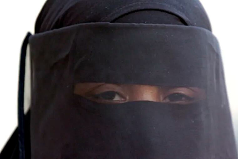 Khadijah Abdus Sabur, an observant Muslim, wears an abaya, a full-length robe, and a niqab, a snug head covering, the entire year.