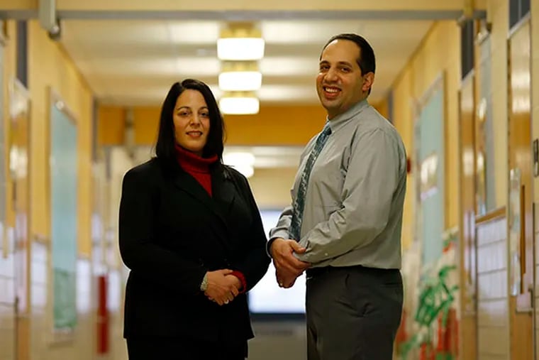 Cayuga School principal Jason Carrion and McKinley School principal Marilyn Carrion-Mejia in the hallway of the Cayuga School on Tuesday, Jan. 6, 2015. They are brother and sister principals in the Philadelphia School District. ( YONG KIM / Staff Photographer )