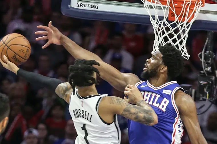 Sixers' Joel Embiid tries to block Nets' D'Angelo Russell  during the 3rd quarter of Game 5 of the first round of the NBA playoffs at the Wells Fargo Center in Philadelphia, Tuesday, April 23, 2019.  Sixers beat the Nets 122-100 to win the first round of the playoffs (4-1).