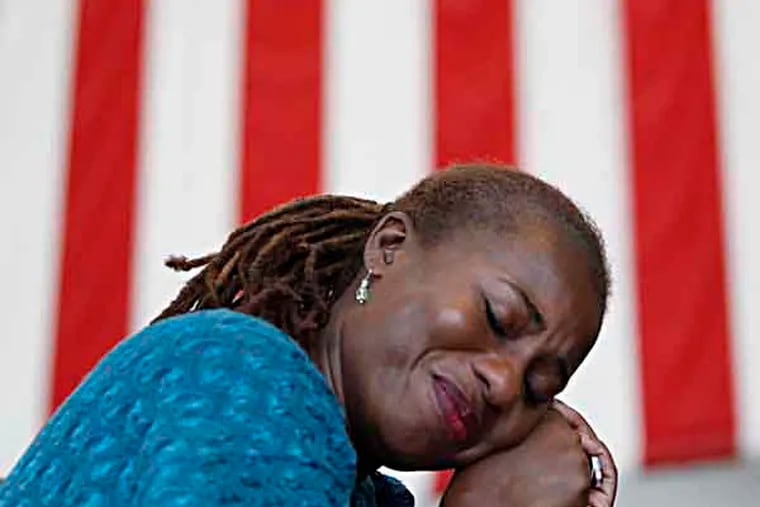 Tanya O'Neill, of Abington, Pa., reacts as singer Alexis P. Suter performs a  song sung during the 1963 March on Washington during a 50th anniversary event of the Martin Luther King Jr. "I Have a Dream" speech at the National Constitution Center in Philadelphia on August 28, 2013. ( DAVID MAIALETTI / Staff Photographer )