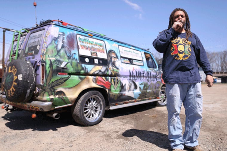 Ed "NJ Weedman" Forchion, smoking a joint last week near his "Weedmobil," has been fighting for marijuana legalization for 15 years. (DAVID SWANSON / Staff Photographer)