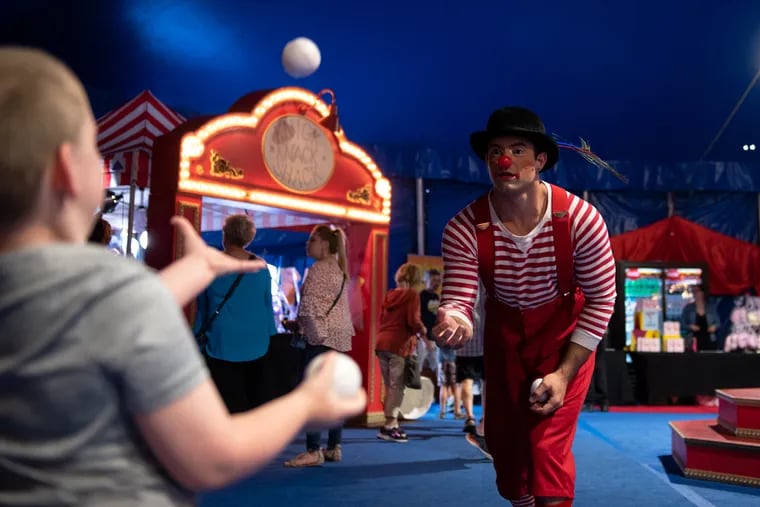 Leo Gonzalez, a performer with the Big Apple Circus, clowns around with guests before the start of a show in Oaks, Pa. on Wednesday, June 5, 2019. KRISTON JAE BETHEL / For the Inquirer