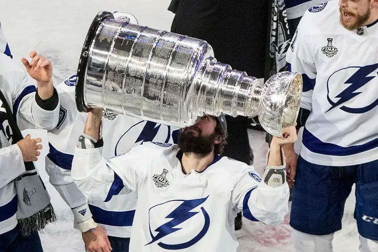 The Tampa Bay Lightning's Nikita Kucherov hoists the Stanley Cup after defeating the Dallas Stars in Game 6 Monday in Edmonton, Alberta.