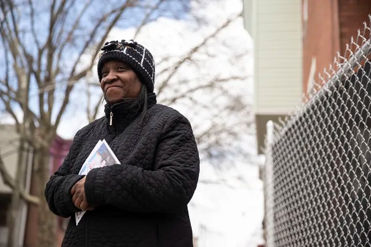 Tracey Lewis posed for a portrait outside of her home in West Philadelphia, Pa. on Monday, March 28, 2022.  Lewis frequently receives mailings and text messages inquiring if she's interested in selling her home.