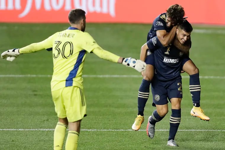 Union midfielder Anthony Fontana, right, gets congratulated by Matt Real after scoring the first of his two goals in the second half.