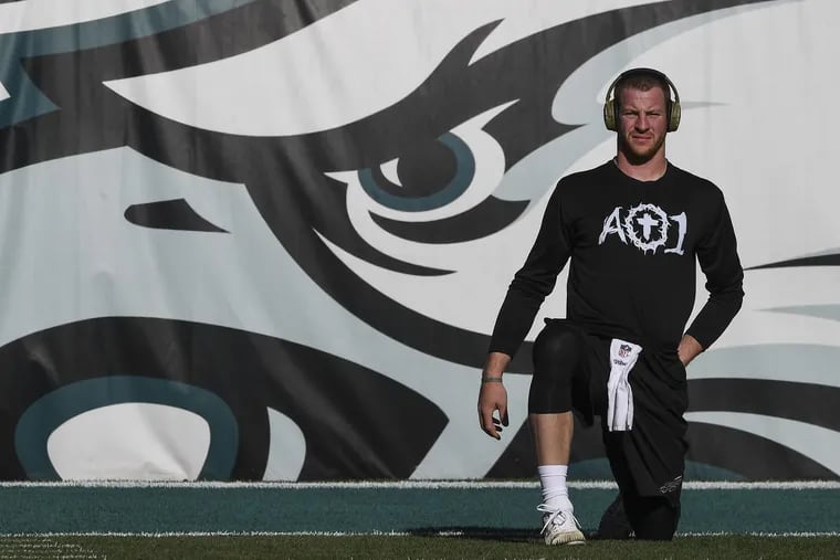 Audience of One, Carson Wentz's Christian-based foundation, is shown across his chest prior to a November 2017 game.