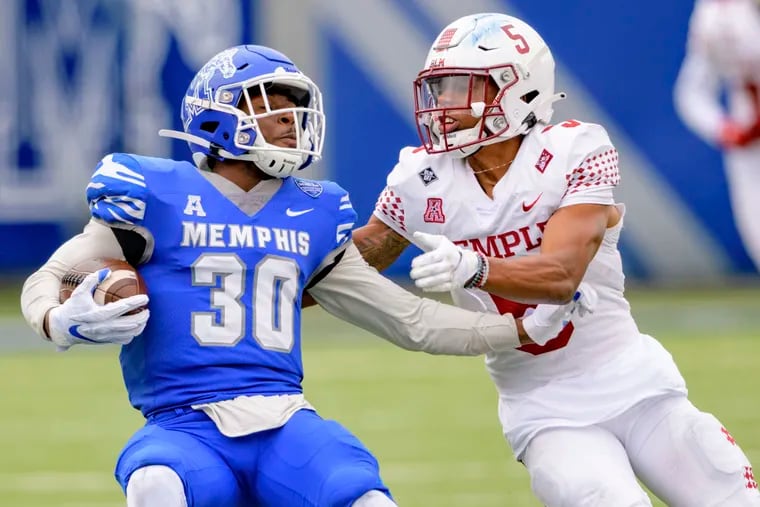 Memphis defensive back Rodney Owens (left) comes up with an interception as Temple wide receiver Jadan Blue looks on.