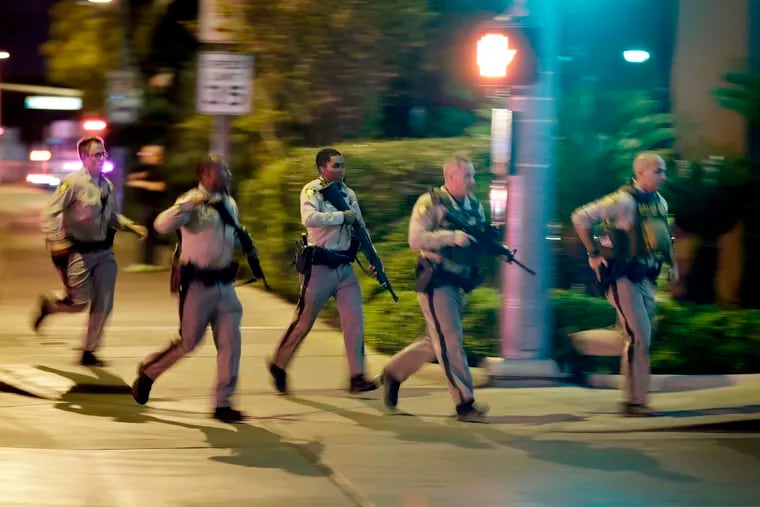 FILE - In this Oct. 1, 2017, file photo, police run toward the scene of a shooting near the Mandalay Bay resort and casino on the Las Vegas Strip in Las Vegas. In documents made public Thursday, Dec. 27, 2018, police in Las Vegas have released transcripts of some officers' accounts about what they saw, heard and did trying to locate and stop a gunman who unleashed the deadliest mass shooting in the nation's modern history almost 15 months earlier. (AP Photo/John Locher, File)