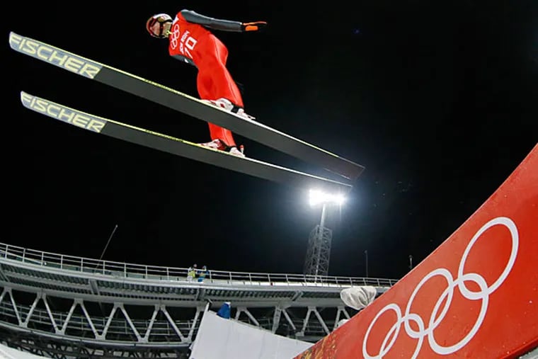 Poland's Kamil Stoch makes an attempt from the normal hill of the men's ski jumping at the 2014 Winter Olympics, Thursday, Feb. 6, 2014, in Krasnaya Polyana, Russia. (Dmitry Lovetsky/AP)
