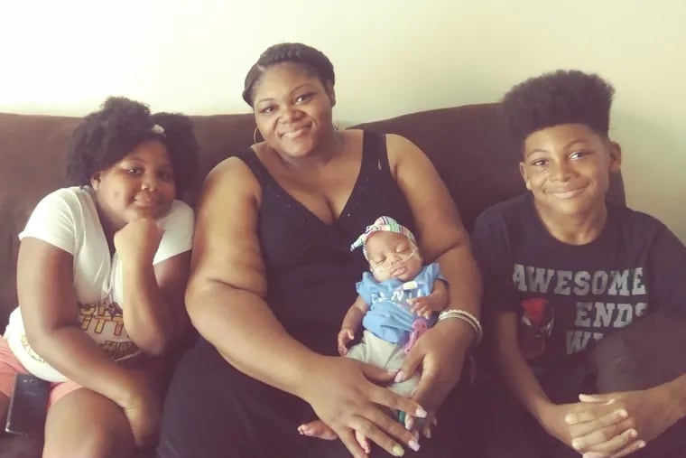 Alyssa with some of her children: KaMaya (left), Hakeem (right), and baby Makenna. Not pictured are her other sons, Jaheem and Emmanuel.