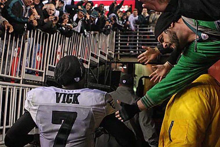 Michael Vick celebrated with fans after leading the Eagles to a record-breaking win over the Redskins. (Ron Cortes/Staff Photographer)