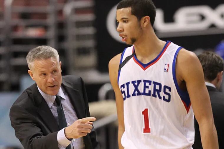 Brett Brown point directions to Michael Carter-Williams. (Yong Kim/Staff Photographer)