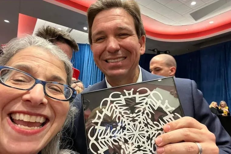 Gov. Ron DeSantis made a tour stop in Iowa where he was gifted a hand-cut snowflake with the word "fascist" hidden within it. We caught up with the artist who makes them. Turns out, it’s not her first time.