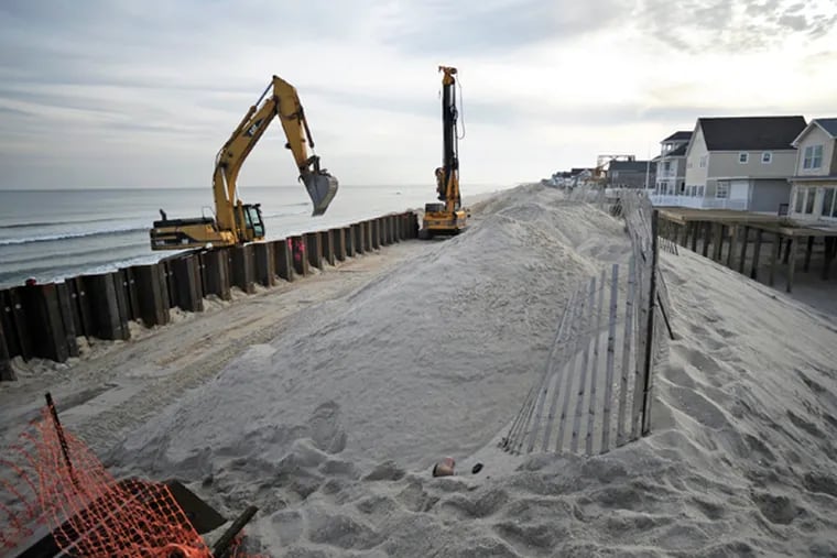 Part of the recovery process from the devastation Hurricane Sandy is the construction of a new seawall on the Normandy Beach section of Brick Township, Dec. 4, 2014. After the wall is sunk into the beach, it will be capped, then covered in dunes, while an additional 200 feet of sand will be dredged and added to the beach on the ocean side. A significant stretch of homes, roadways, and beachfront along Route 35 between Mantoloking and Sea Isle City were ravaged. (TOM GRALISH/Staff Photographer)