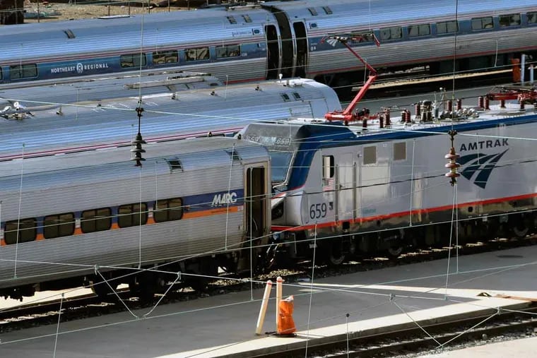 A Maryland Area Regional Commuter (MARC) rail car sits in the Amtrak yard next to 30th Street Station.