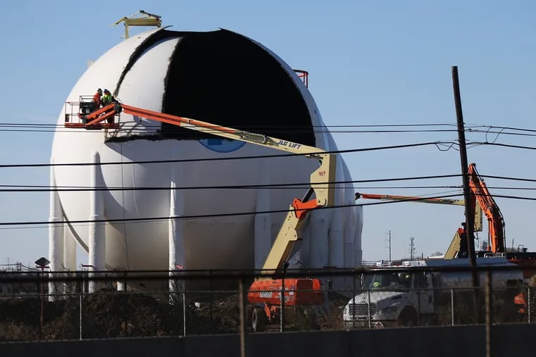 Workers disassemble butane tanks in the north yard of the former Philadelphia Energy Solutions refinery in South Philadelphia in fall 2020. The PES site was purchased by Hilco Redevelopment Partners, which plans to demolish the refinery and build warehouses in its place.