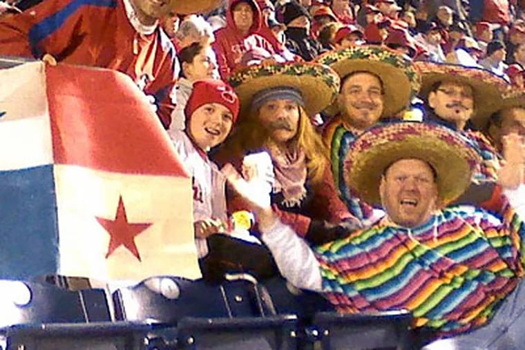 Members of the Chooch-Chooch Train fan club from Kensington and Port Richmond show their love for Phillies catcher Carlos “Chooch” Ruiz with authentic Panamanian flag, Panama hat and Panamanian beer.