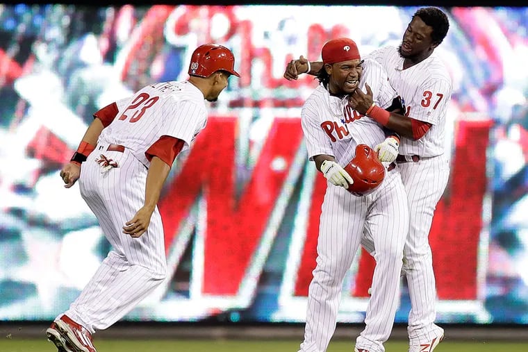 Maikel Franco celebrates his game-winning hit with teammates Odubel Herrera and Aaron Altherr.
