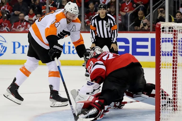 Flyers center Sean Couturier slips the puck past New Jersey goaltender Mackenzie Blackwood in the shootout Friday night at the Prudential Center in Newark, N.J. The Flyers beat the Devils in the shootout, 4-3.