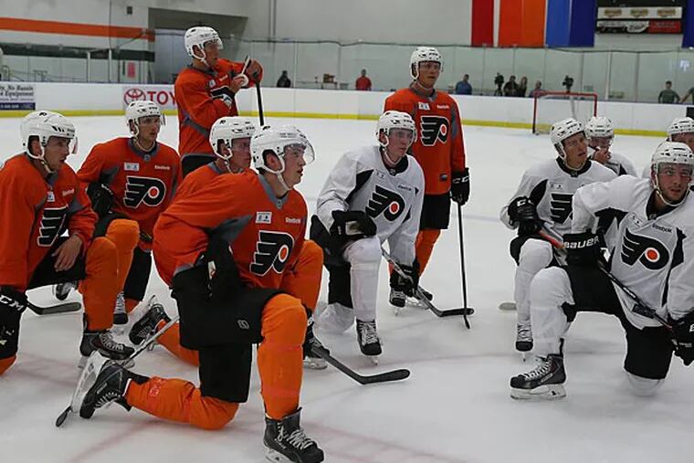 Defensemen gather on the ice during the Flyers developmental camp.