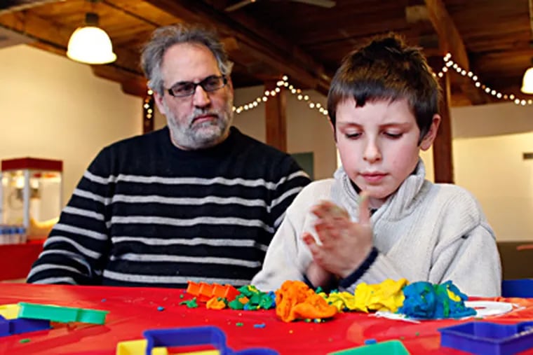 George Kaplan-Mayer, 9, plays with his father, Fred Kaplan- Mayer, at the Purim carnival for special-needs children at Mishkan Shalom in Roxborough. (Laurence Kesterson / Staff Photographer)