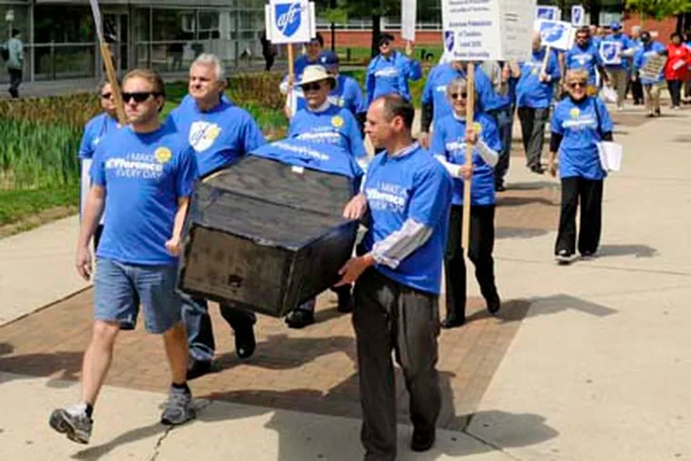 Carrying a symbolic coffin - "the death of education" - members of Rowan University's American Federation of Teachers march on campus April 25, 2012 in protest of what they say are delayed contract negotiations. Faculty have been working without a contract since June 30. ( TOM GRALISH / Staff Photographer )