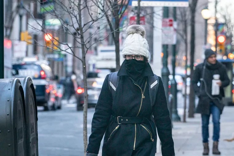 A pedestrian bundles up against the cold on Walnut Street, in Philadelphia, January 21, 2019.